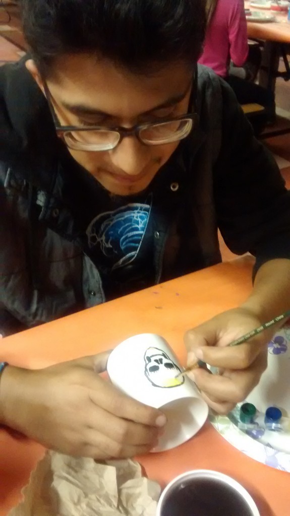 Jovany Rios works on a mug at one of the art workshops.