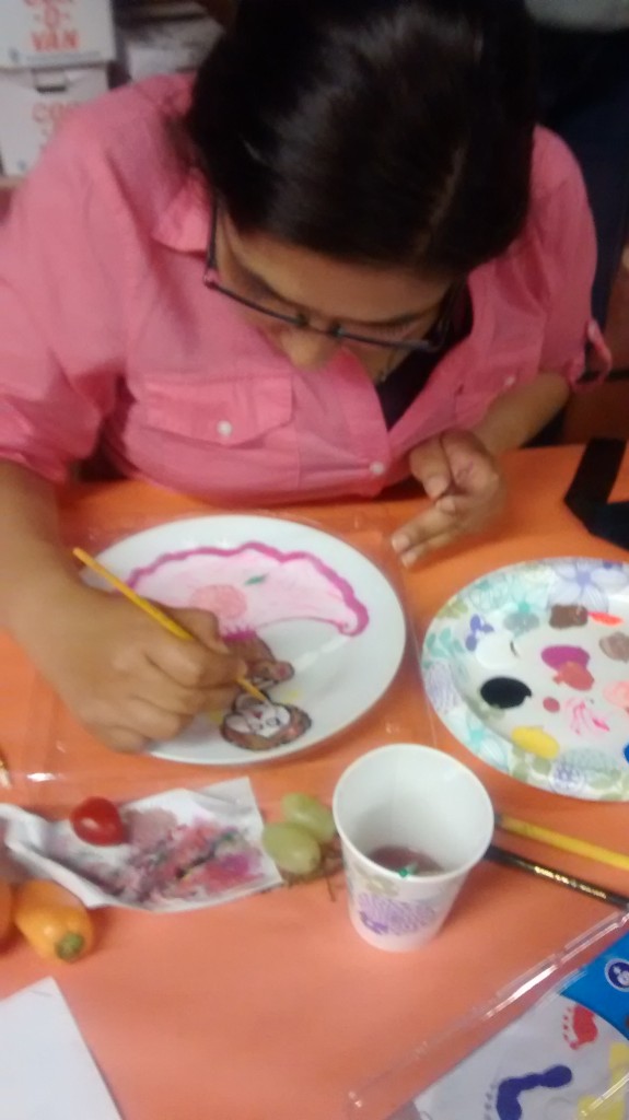 Yessenia Serratos works on a plate at a recent art workshop.