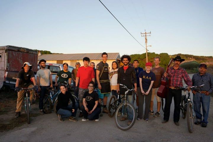 Ben, center in orange shirt and black jacket, at Farm Bike Repair Day in 2013.