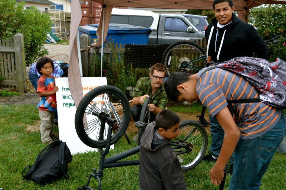 Kyle, center, works on bikes at the Farmers Market.