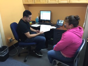 Ortega assists a tax program participant in 2016.
