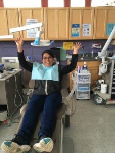 Yesenia, one of Puente's health promoters, celebrates a clean mouth!